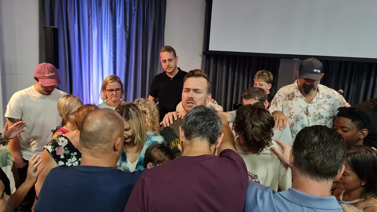 People praying together at His Kingdom Church